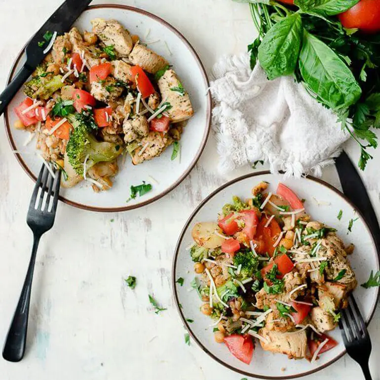 Recipe image of two plates of Italian chicken and farro with cutlery