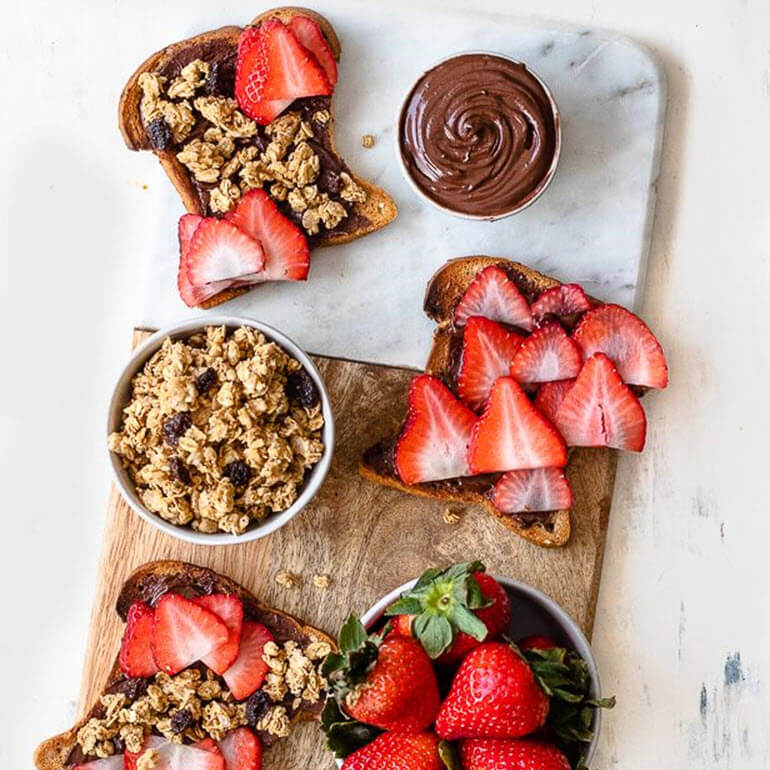 Recipe image of Cascadian Farm Organic Strawberry Chocolate Hazelnut Granola Toast with sides of granola and strawberries